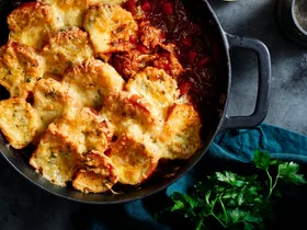 This one-pot chuck steak casserole is topped with cheesy garlic bread