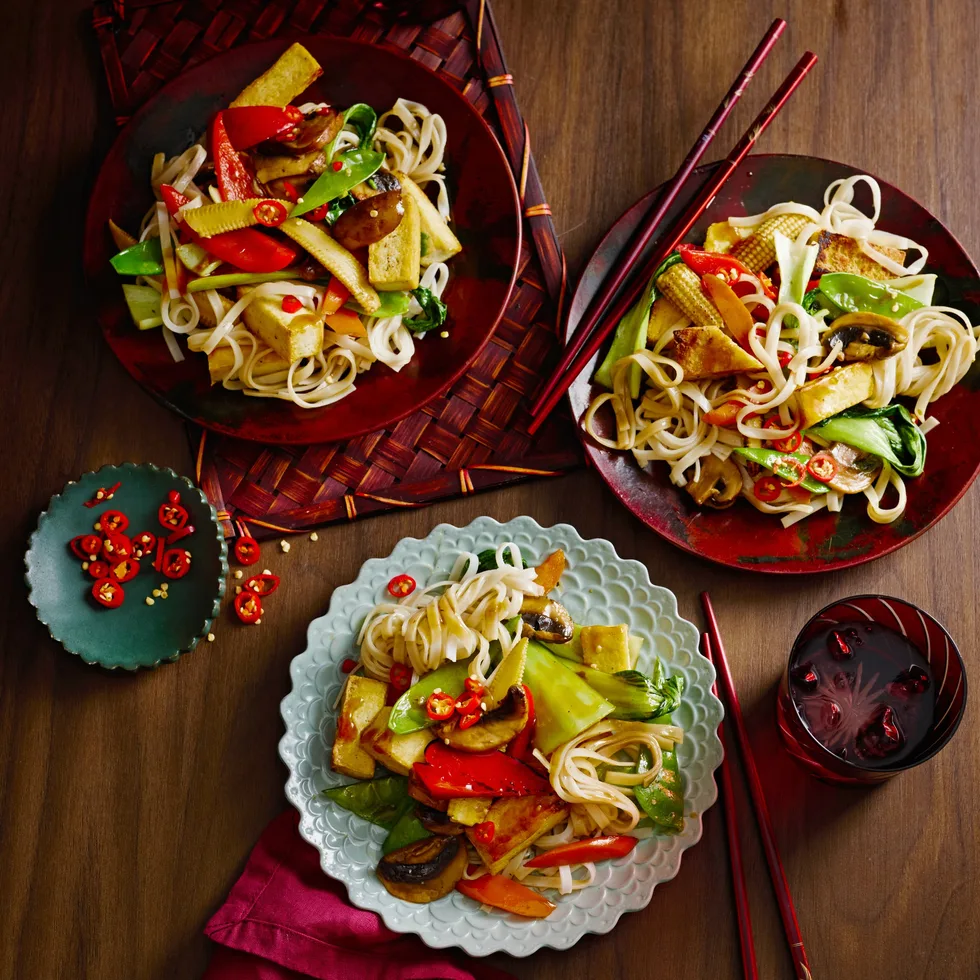 midweek stir fry with tofu in three separate bowls with red cloth underneath