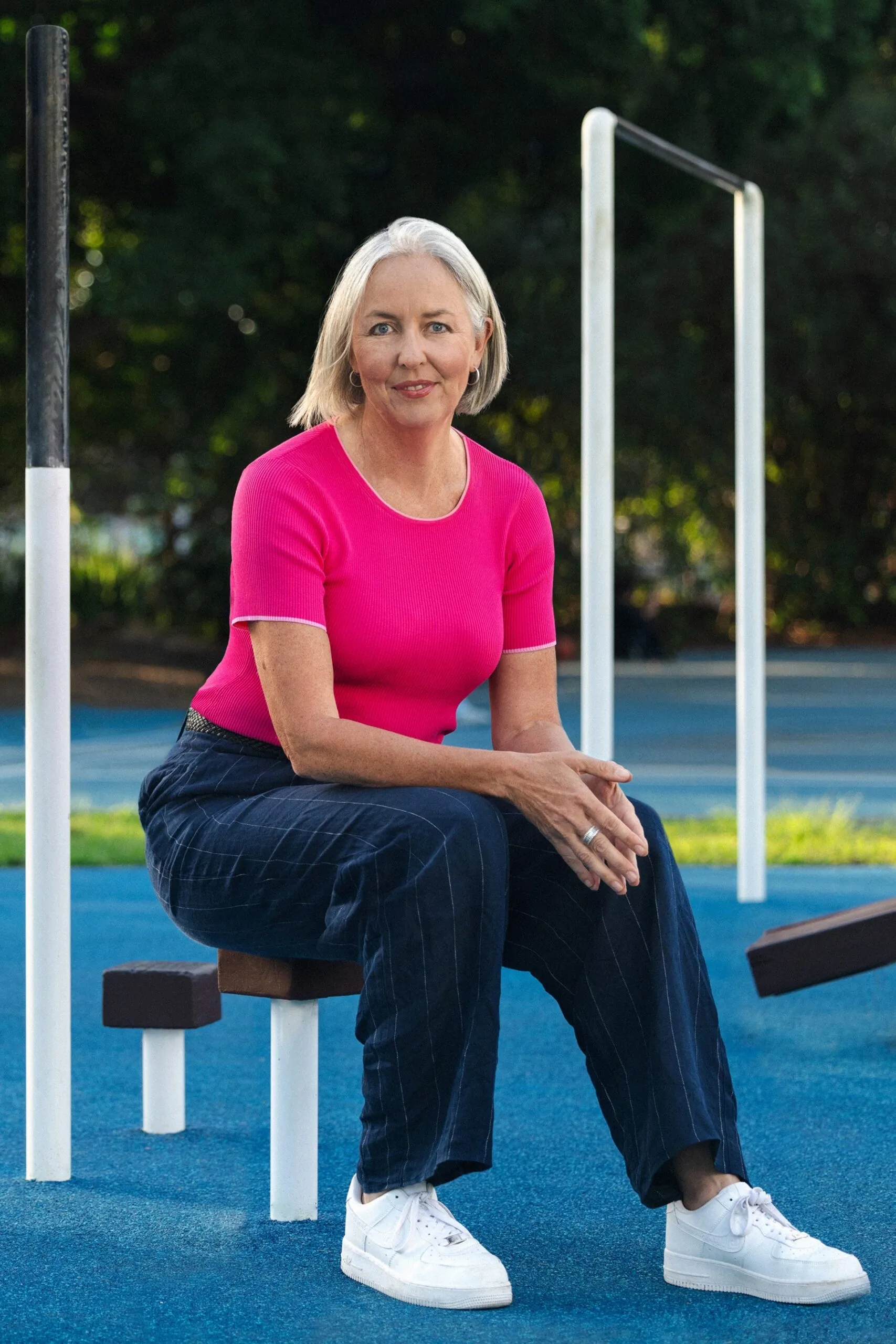 portrait of liz ellis at outdoor gym wearing pink tshirt