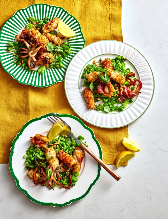 squid broad bean and pea salad in three bowls with green accents and yellow tablecloth behind