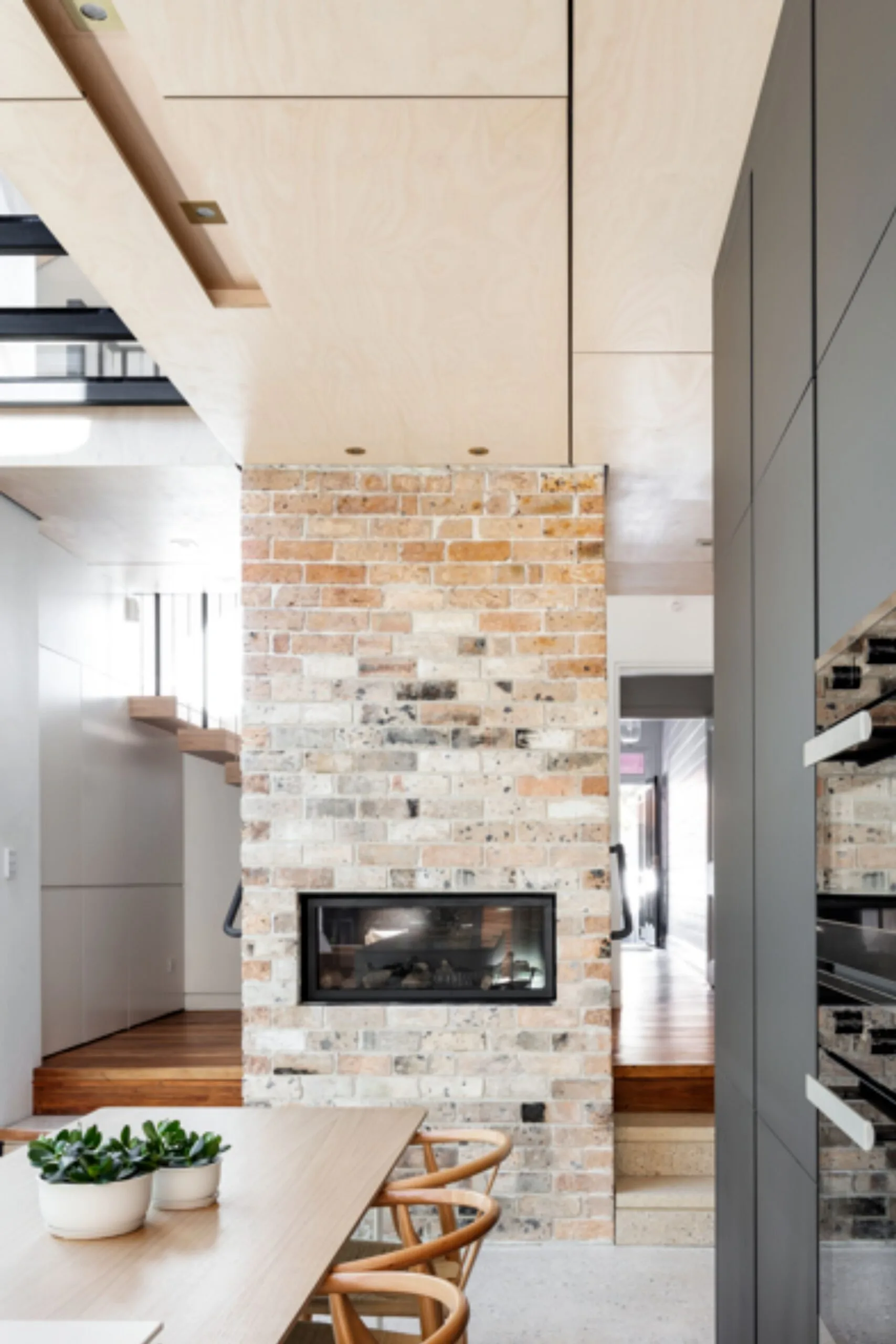 The exposed brick fireplace in the Northern Beaches home.