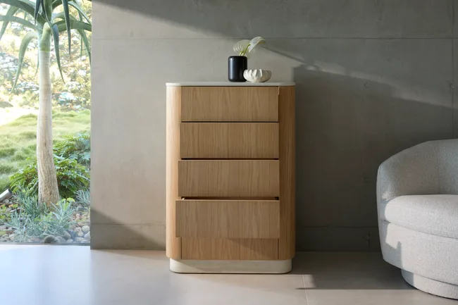 tallboy in light brown oaky colour with pot plant on top