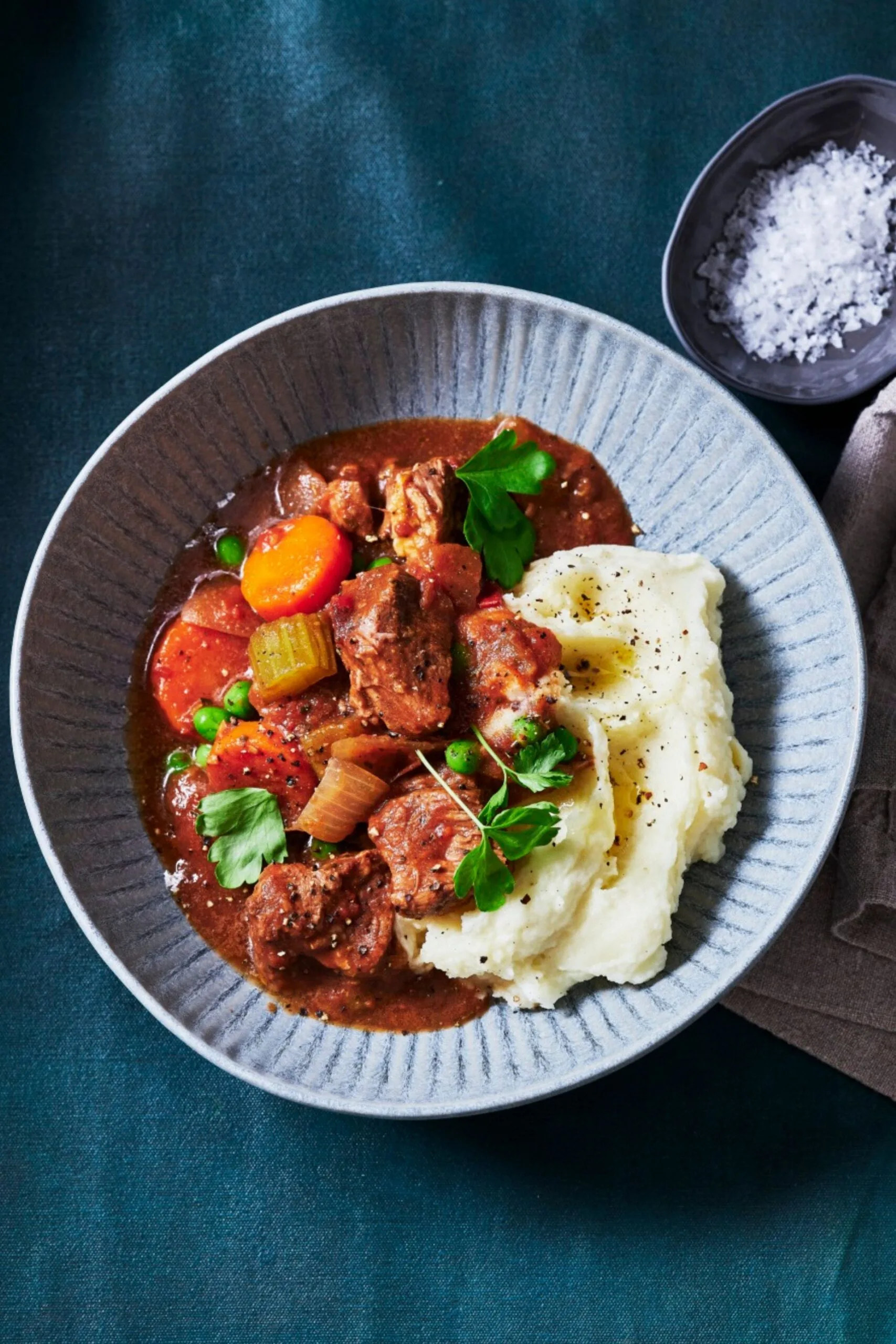 slow cooker beef stew with carrot celery and chuck steak and side of mashed potato