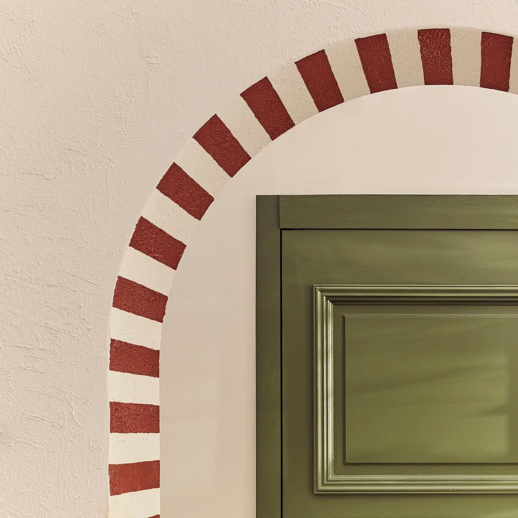 Striped archway in beige and burgundy with a green door in the background.