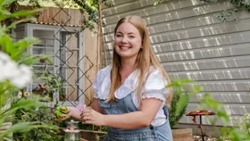 Craft DIY expert and creator Brooke Styles picking flowers in a garden