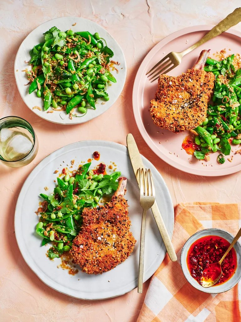 clarissa feildel's crumbed pork cutlets on plate with spring green salad of peas and edamame on the side