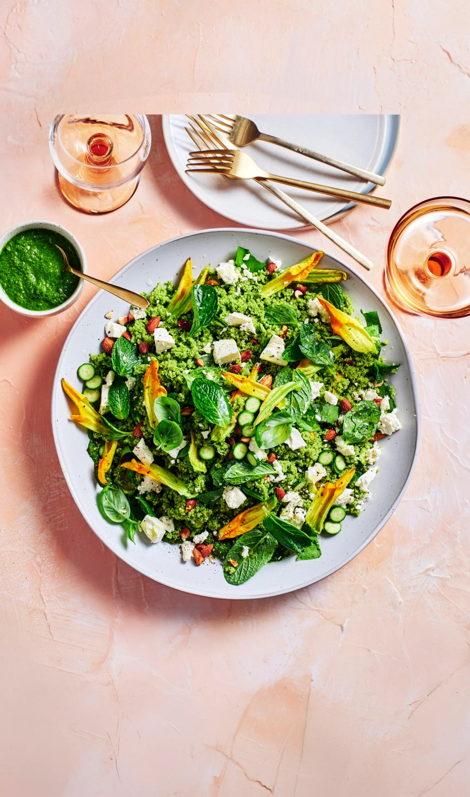 spring green couscous with kale spinach apple and sorrel sitting in bowl on pink background