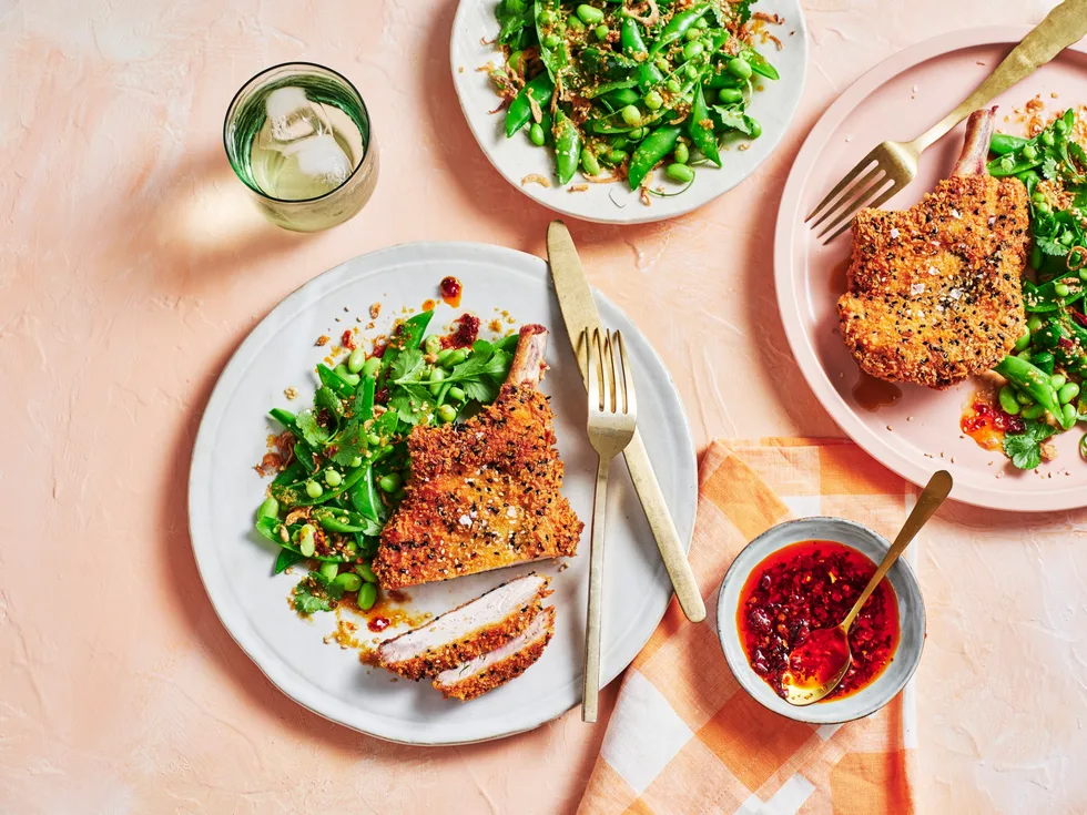clarissa feildel's crumbed pork cutlets on plate with spring green salad of peas and edamame on the side