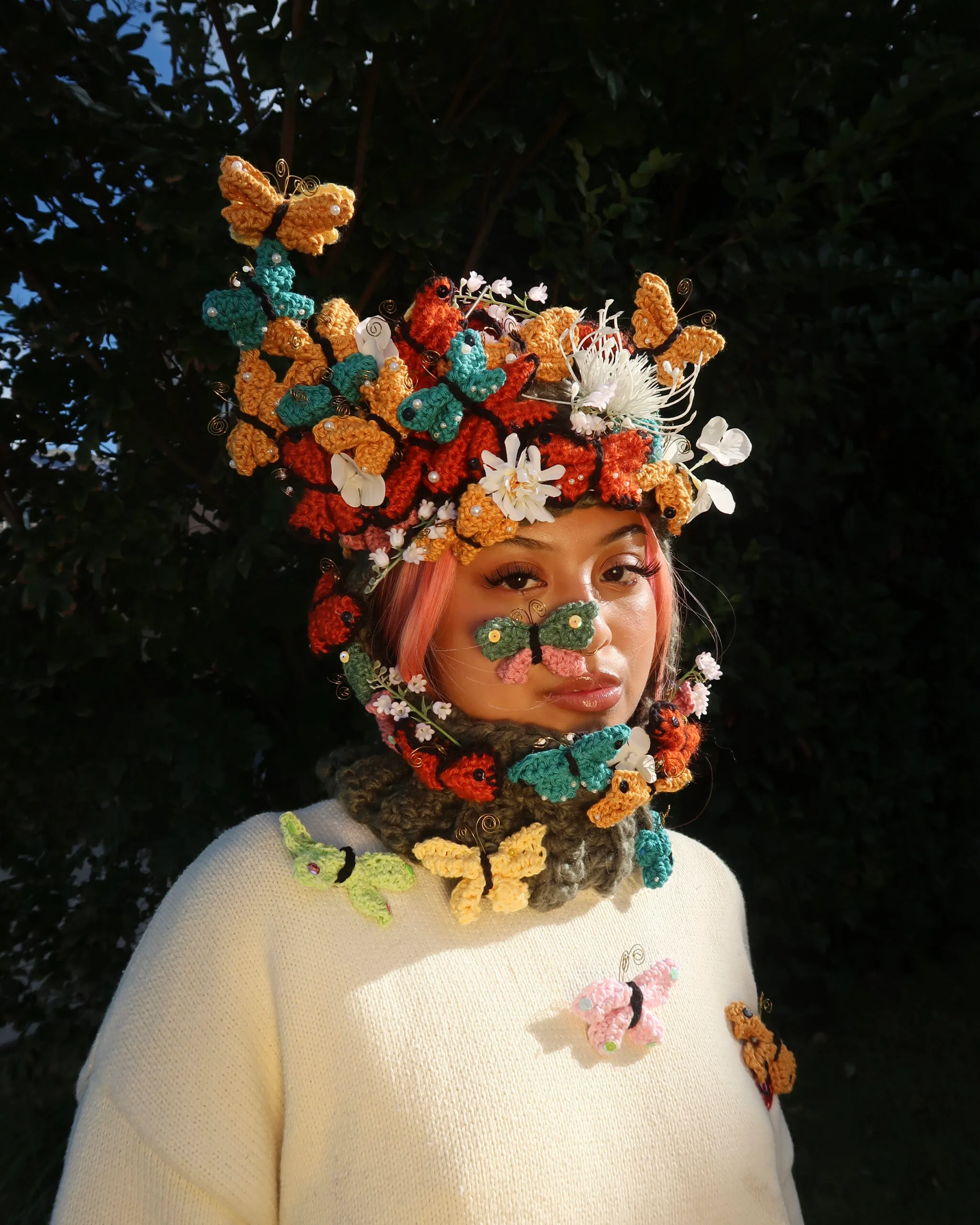 katelyn leonardo with crocheted balaclava with butterflies and flowers on top