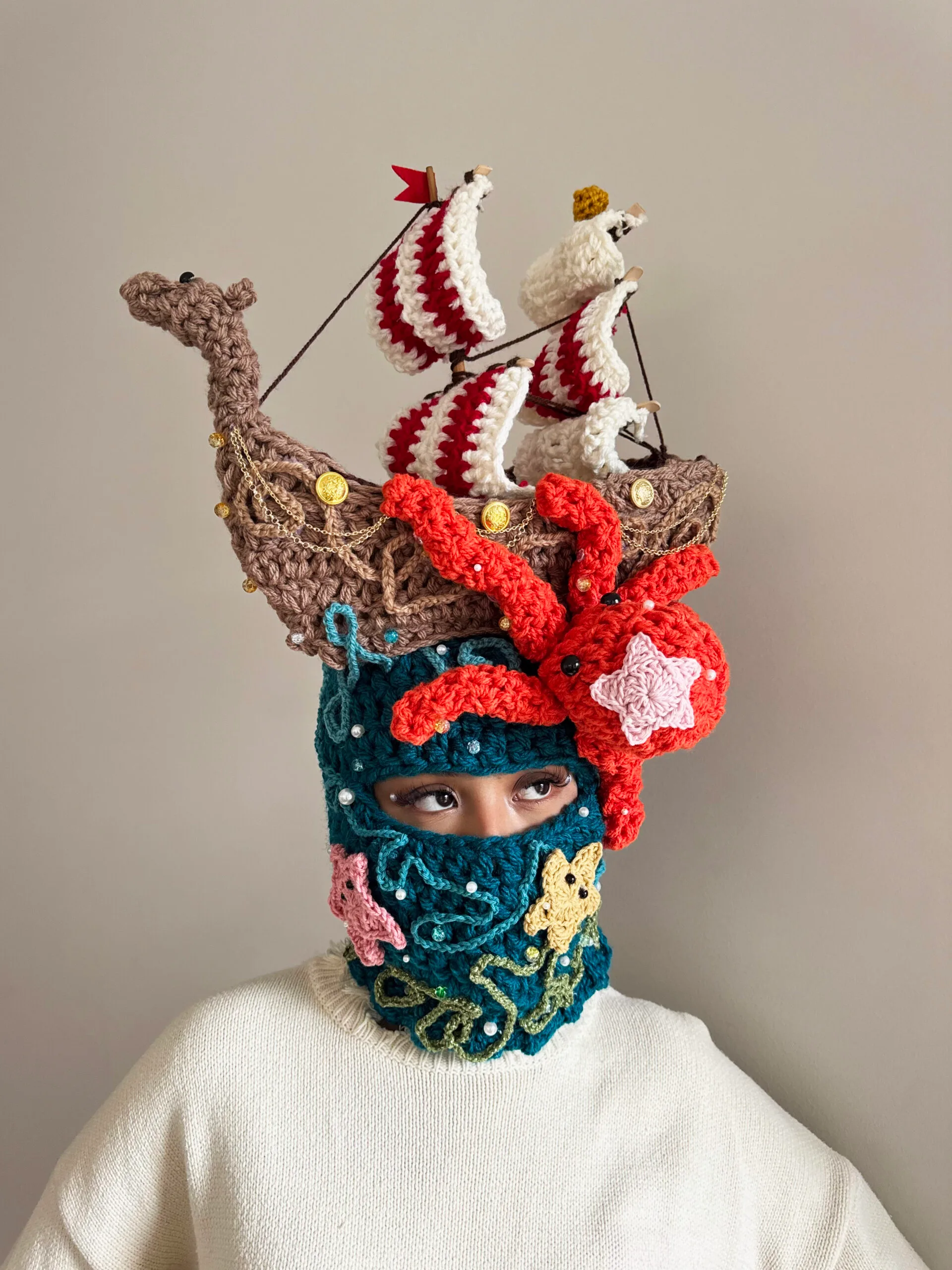 katelyn leonardo with crocheted hat on with pirate ship and giant red kraken on the side