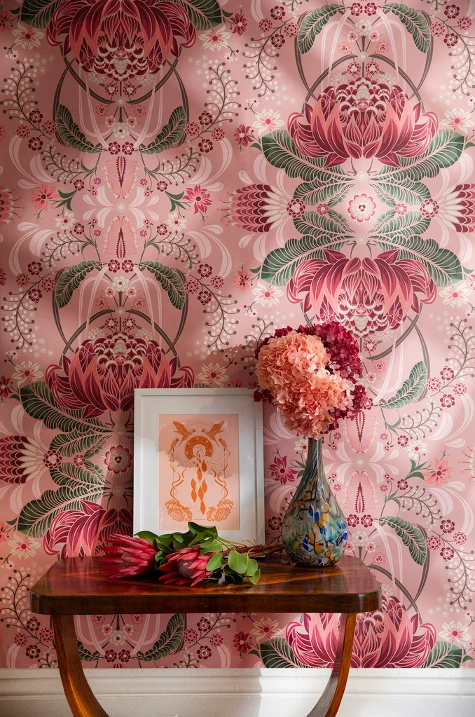 Pink and green Milton and King floral wallpaper with a rosewood side table and vase with flowers