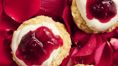 Rose petal and strawberry jam with cream on scones