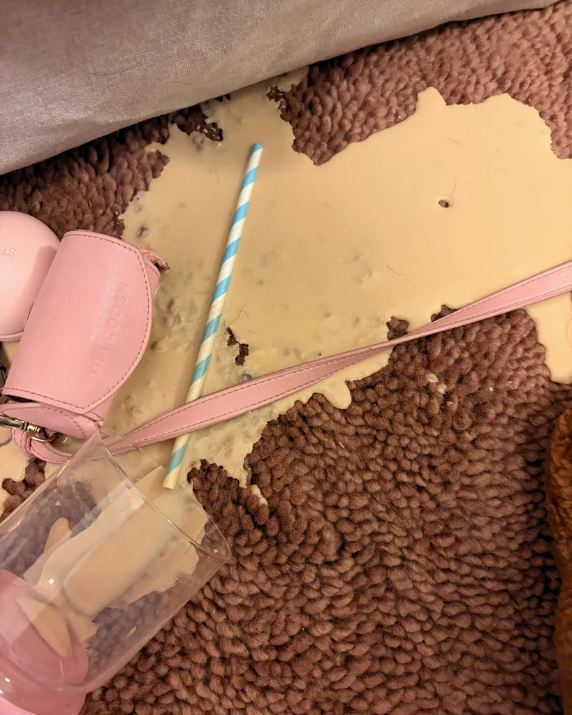 A spilled iced latte on Double's Otago Washable Wool Rug in Terracotta for the Spill Test segment of the review.