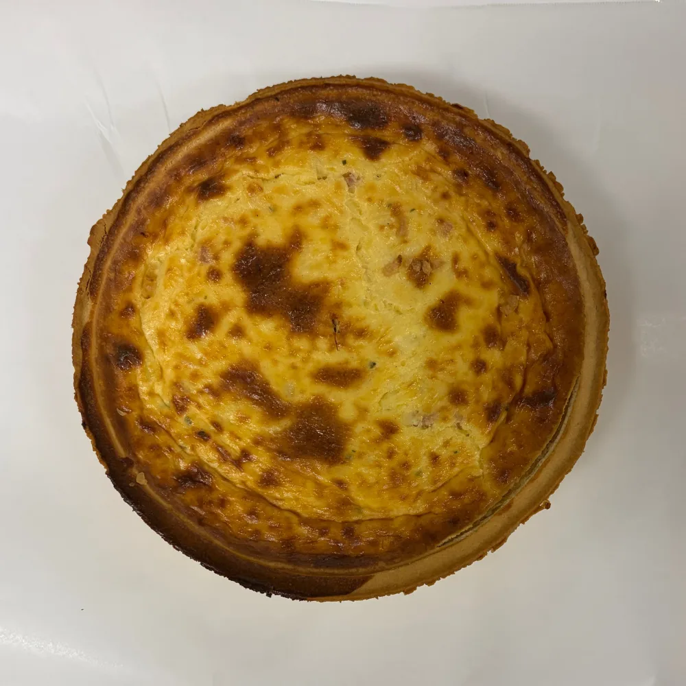 thick crust on home chef quiche lorraine with lots of browning on top sitting on white tray