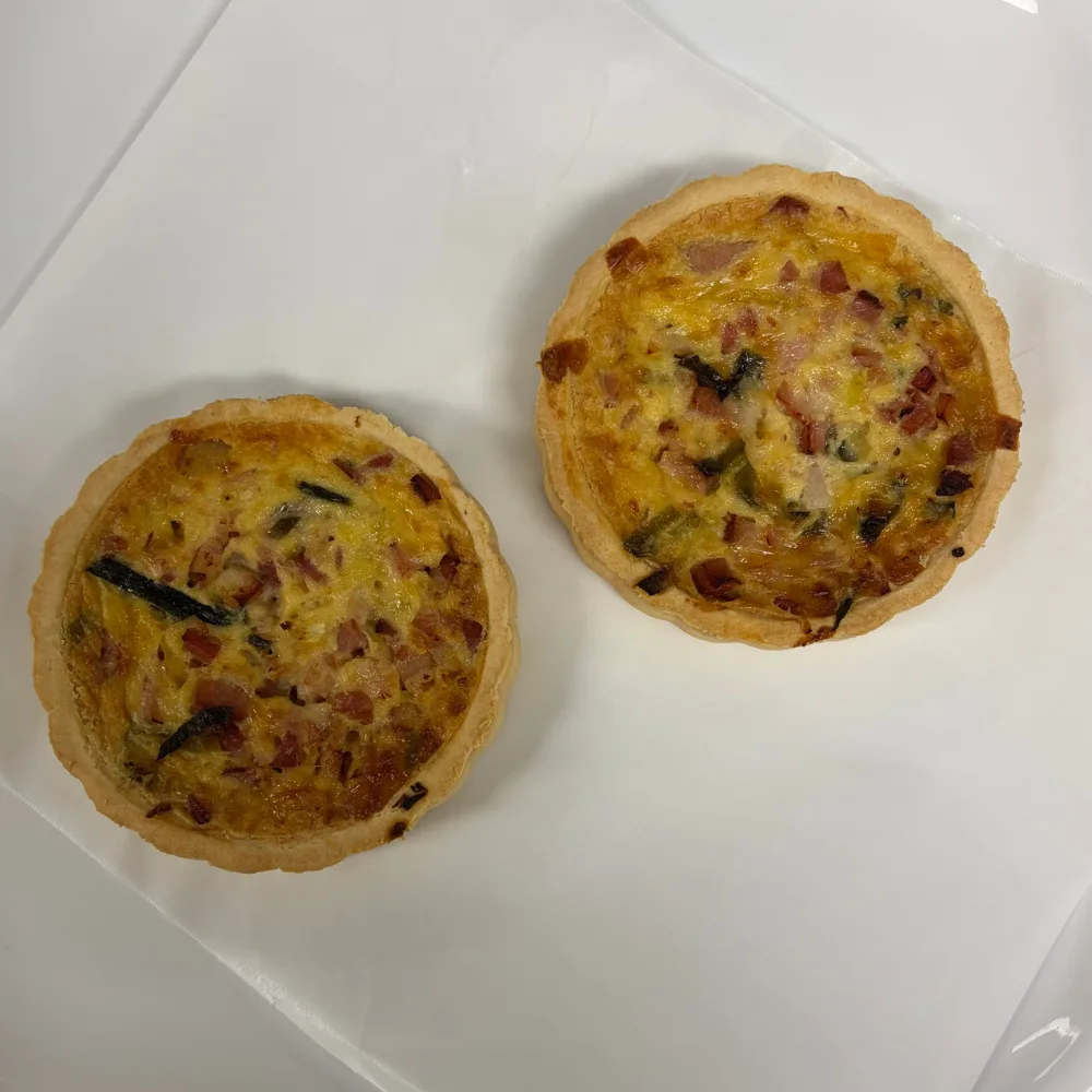 Ruffie Smokey Bacon Leek & Cheddar Quiche two quiches sitting on white tray