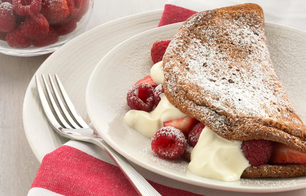 Chocolate souffle omelette with berries and yoghurt - Better Homes & Gardens Australia