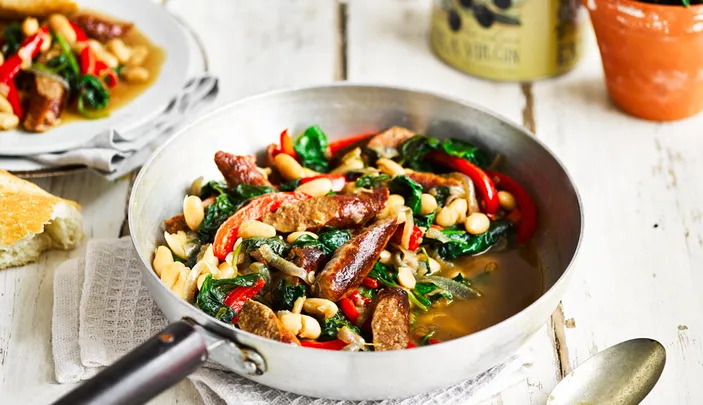 Beef sausages served with cannellini beans and vegetables