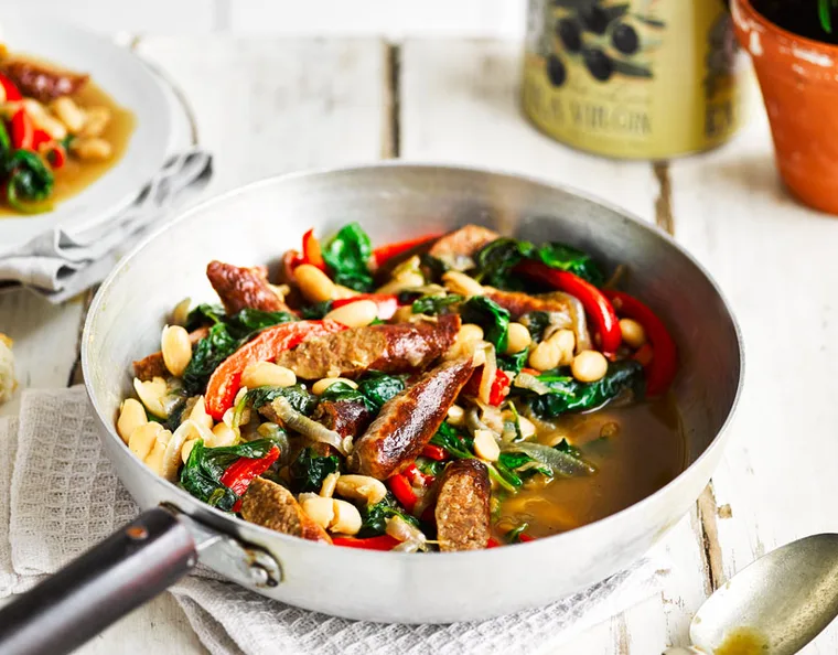 Beef sausages served with cannellini beans and vegetables