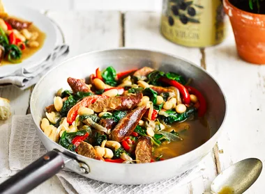 Beef sausages served with cannellini beans and vegetables