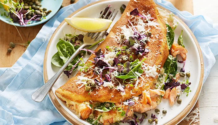 Souffle omellette with smoked salmon, capers, lemon and rocket