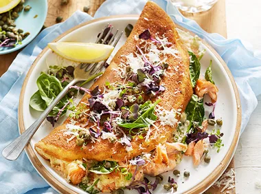 Souffle omellette with smoked salmon, capers, lemon and rocket