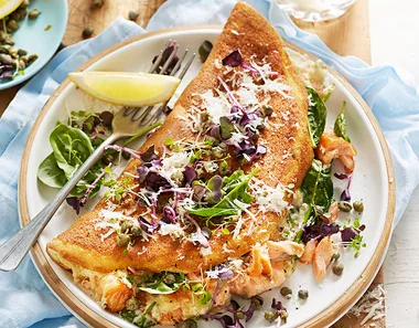 Souffle omellette with smoked salmon, capers, lemon and rocket