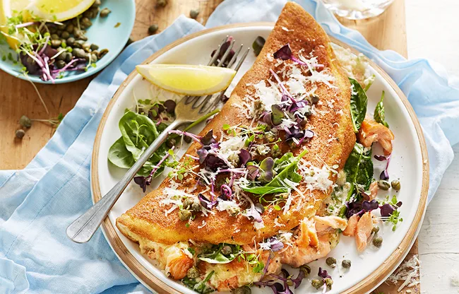 Souffle omellette with smoked salmon, capers, lemon and rocket