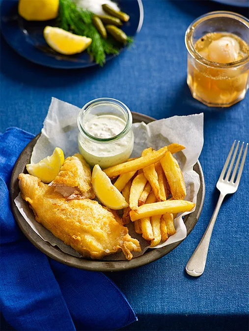 Fish and chips on a plate with white dipping sauce