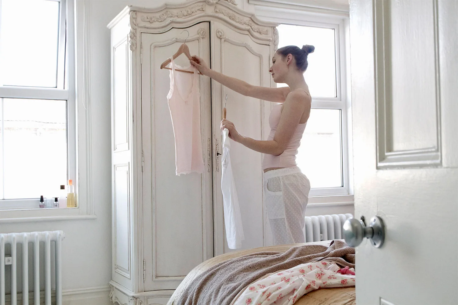 Girl looking at clothes in front of wardrobe