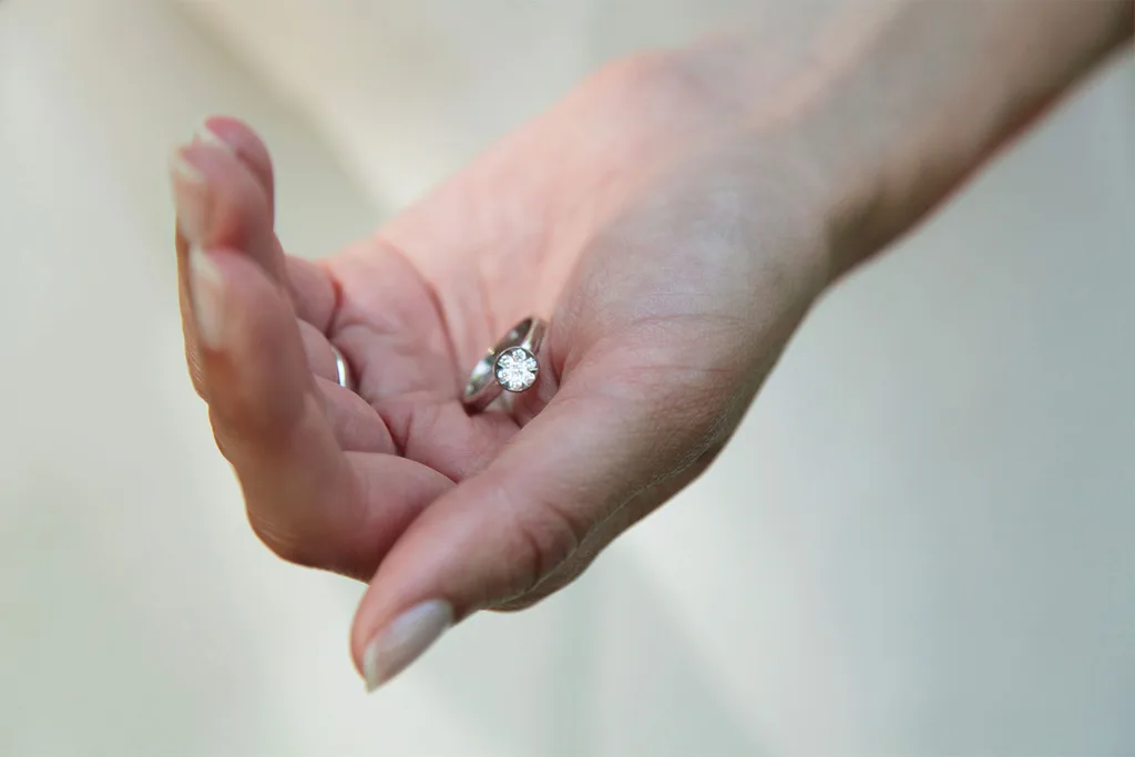Hand holding diamond ring