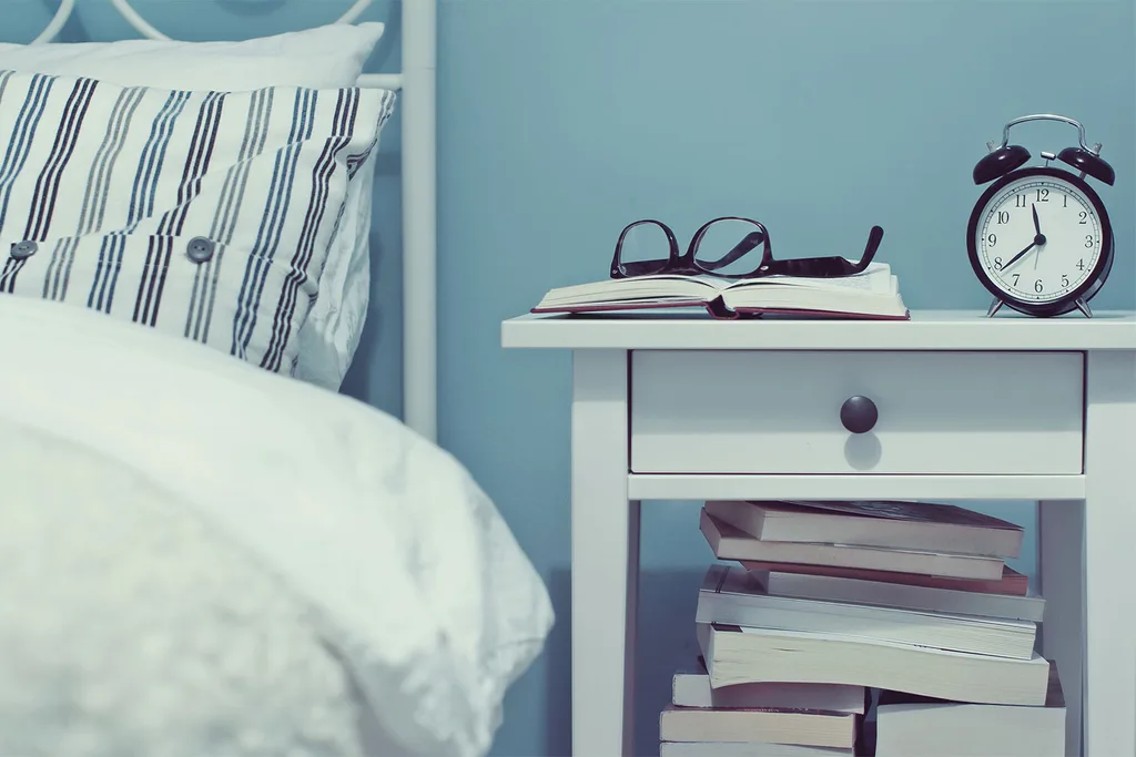 Bedside table with books on it.