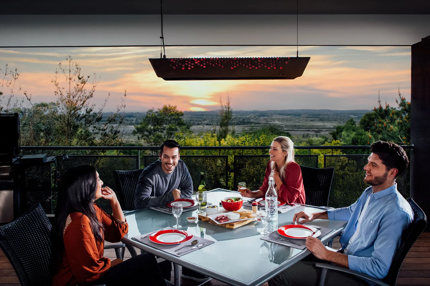 People sitting at outdoor table setting.