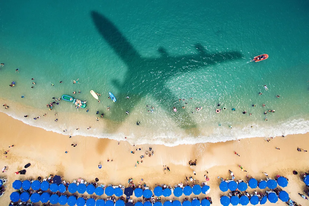 Plane flying over beach