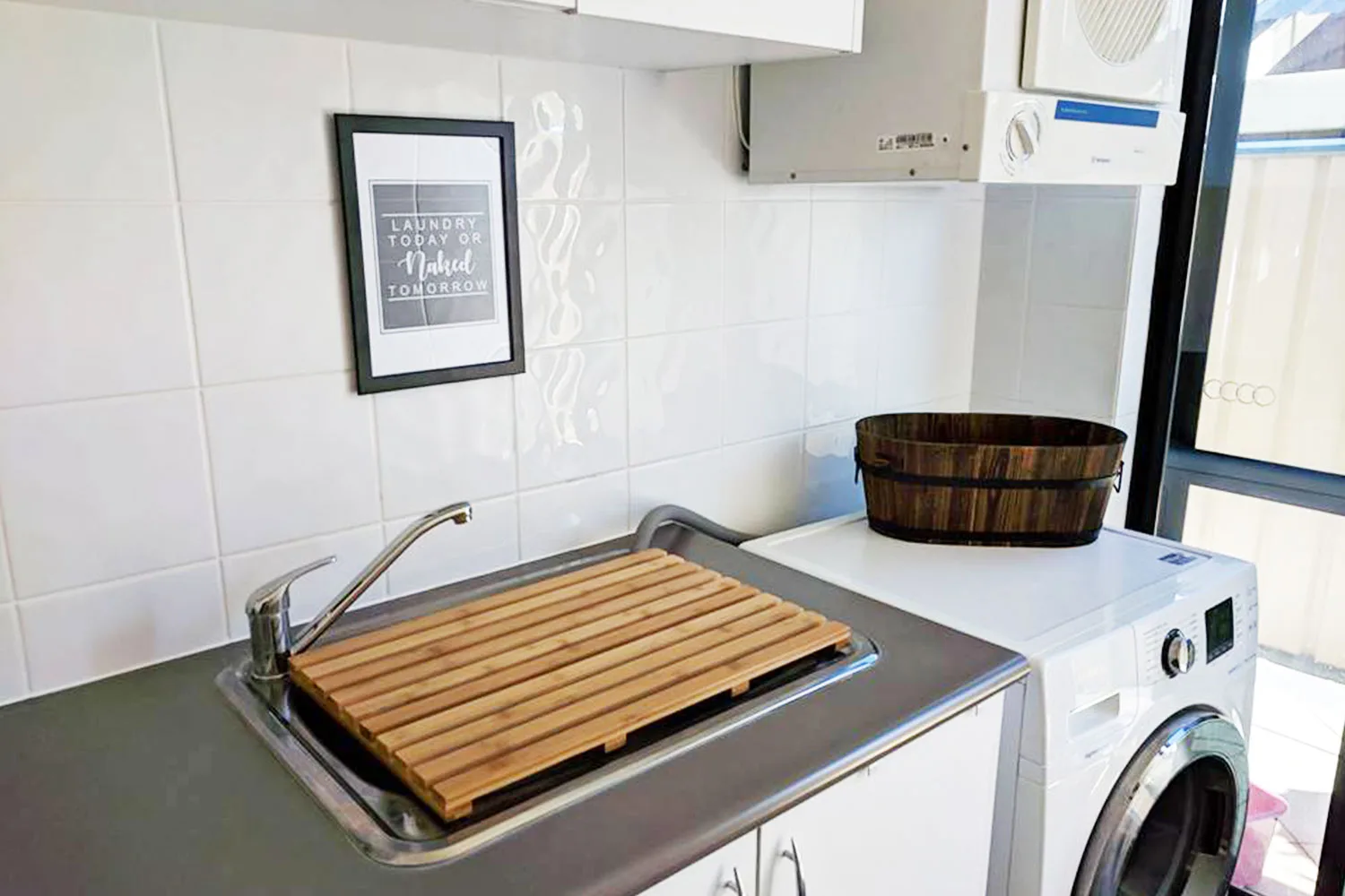 Kmart's bamboo duck board can fit across laundry sinks to make a stylish cover.