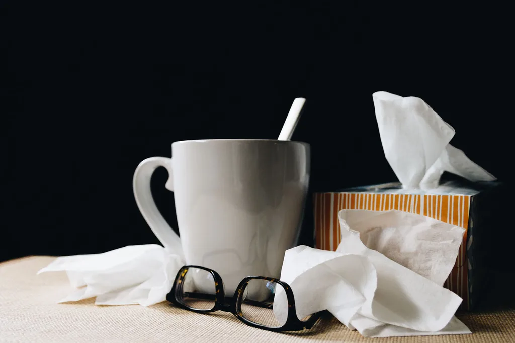 mug with glasses, tissues and spoon