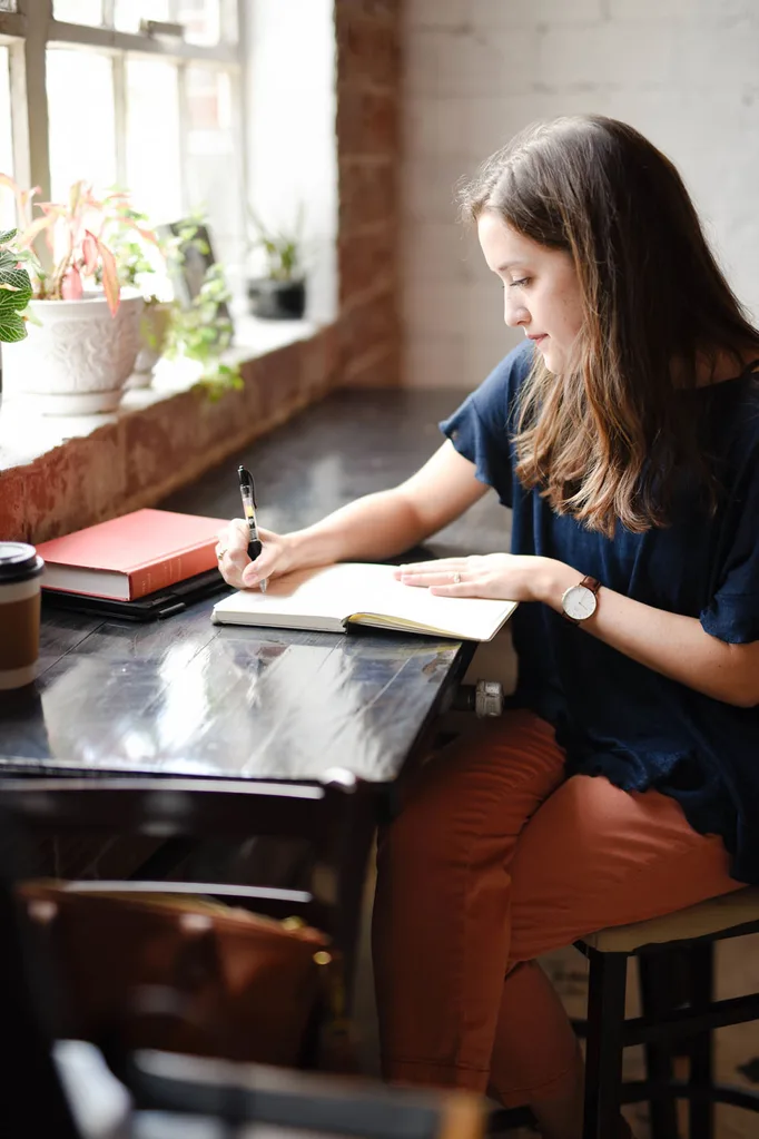 woman writing in journal