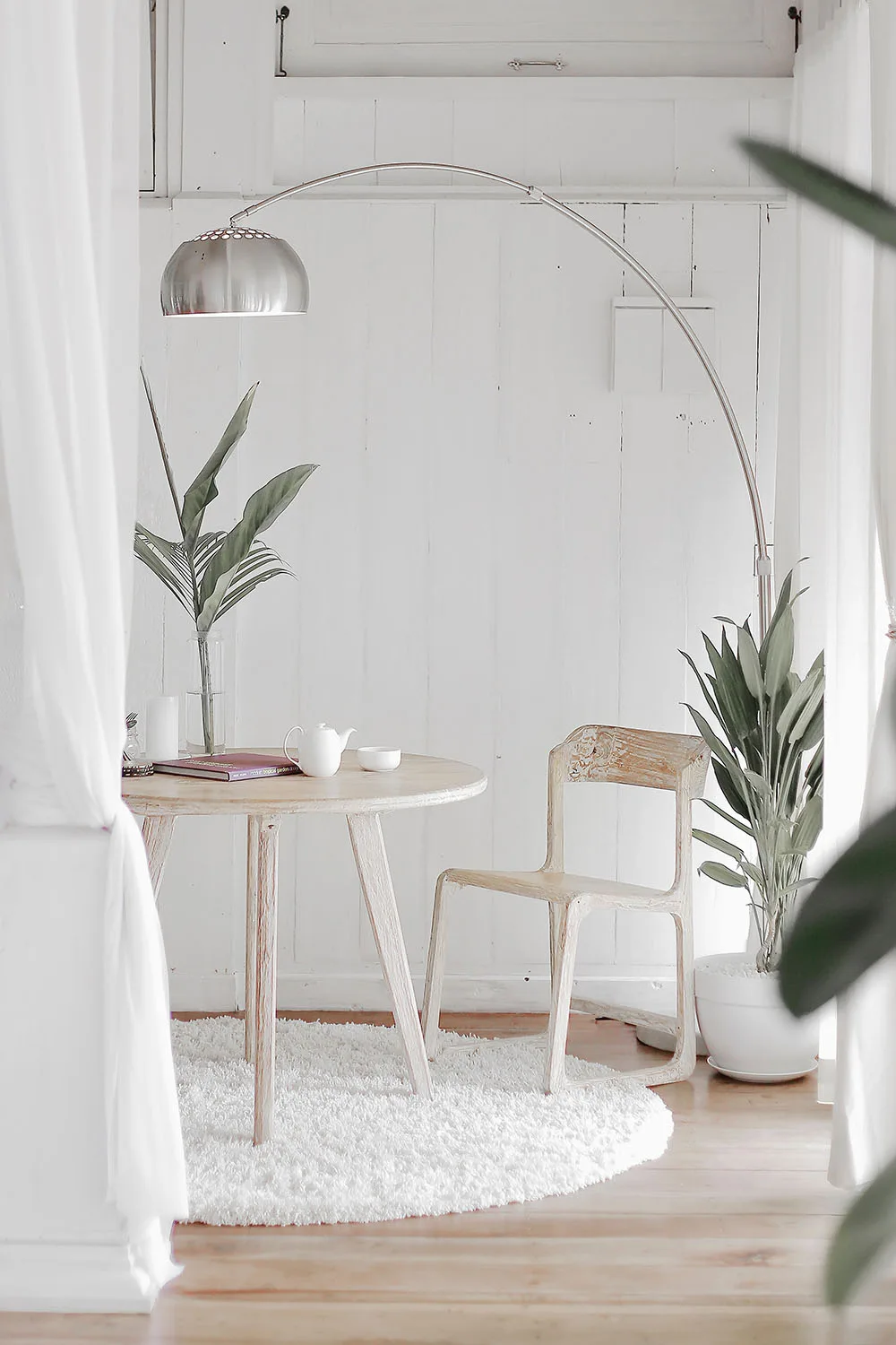 white interior with rug chair and lamp