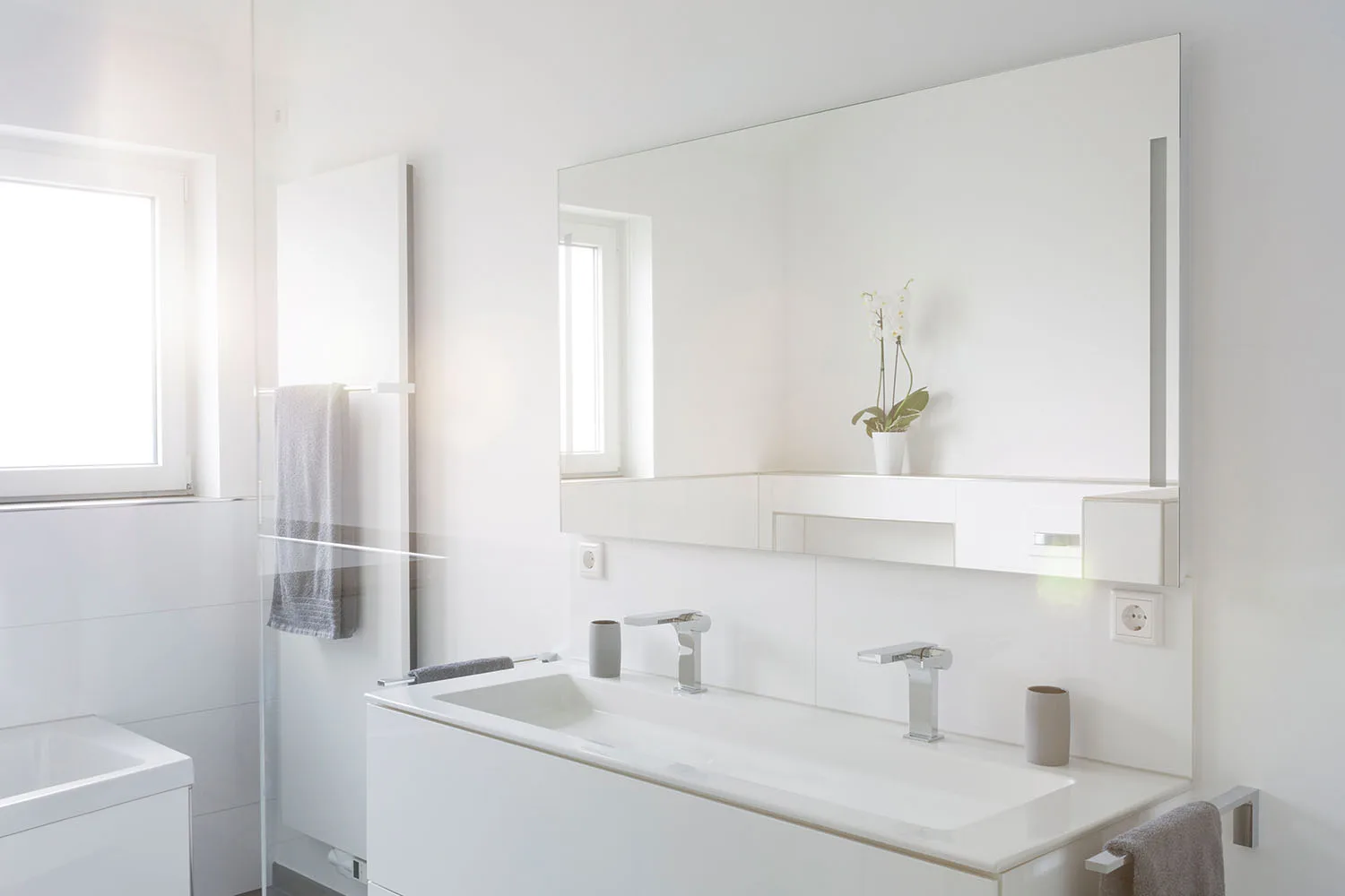 White bathroom with mirror in foreground