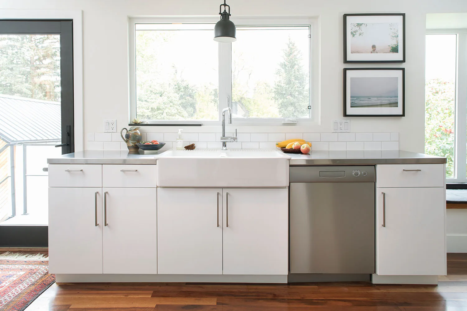 white kitchen with dishwasher and timber floor