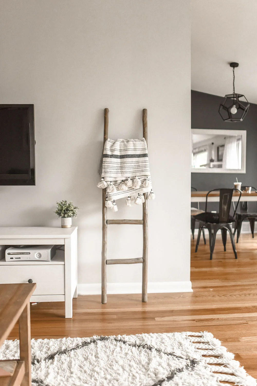 timber ladder in living room with white walls