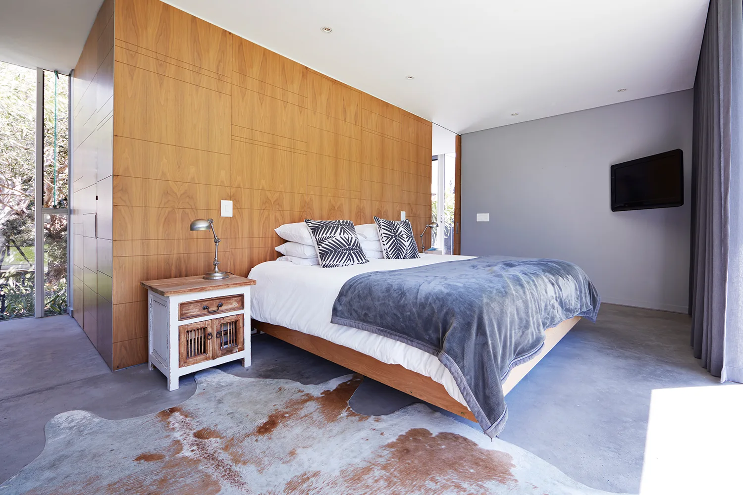 bedroom with timber wall and grey carpet