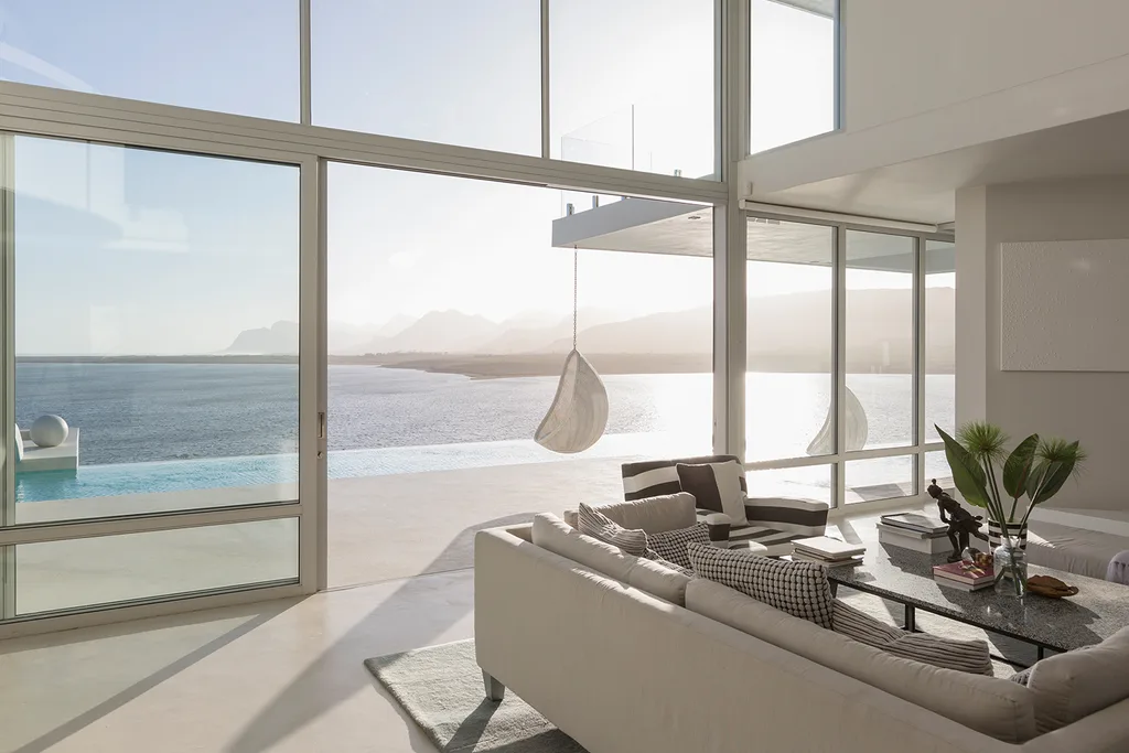 coastal home with floor to ceiling windows at beach