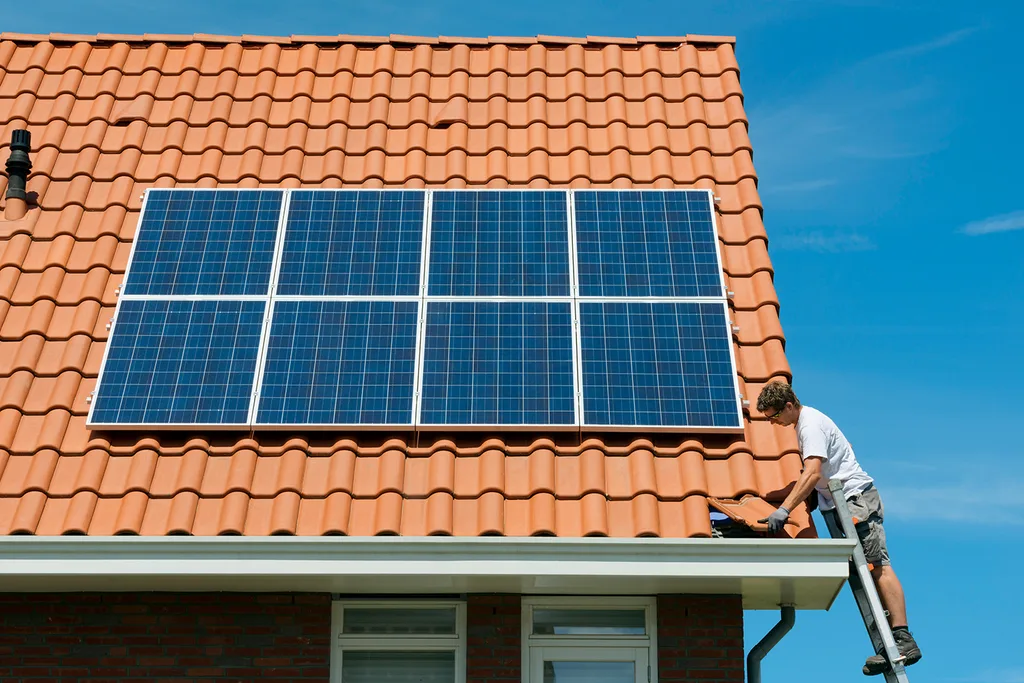 solar panels being attached to roof of house