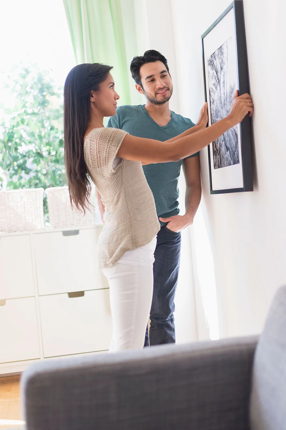 Woman hanging a picture