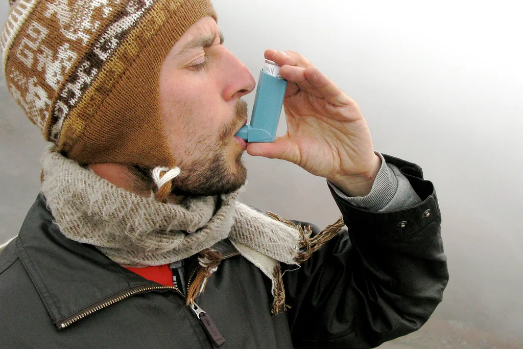 man using asthma ventolin puffer