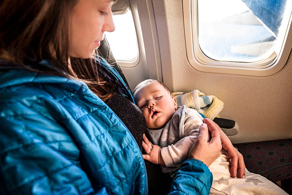 mother with baby on plane