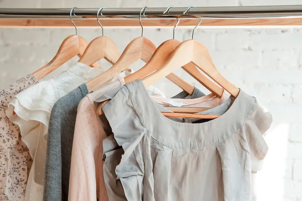 shirts hanging on wooden hangers