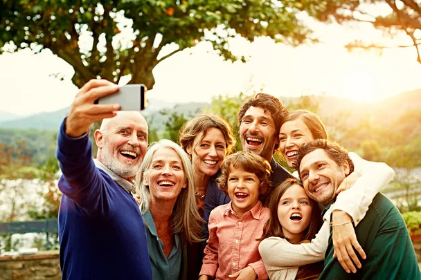 family taking selfie using phone