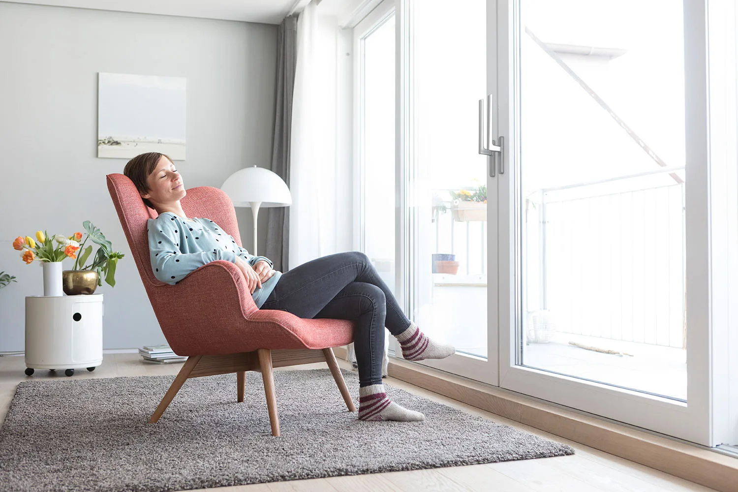 woman napping in a pink chair