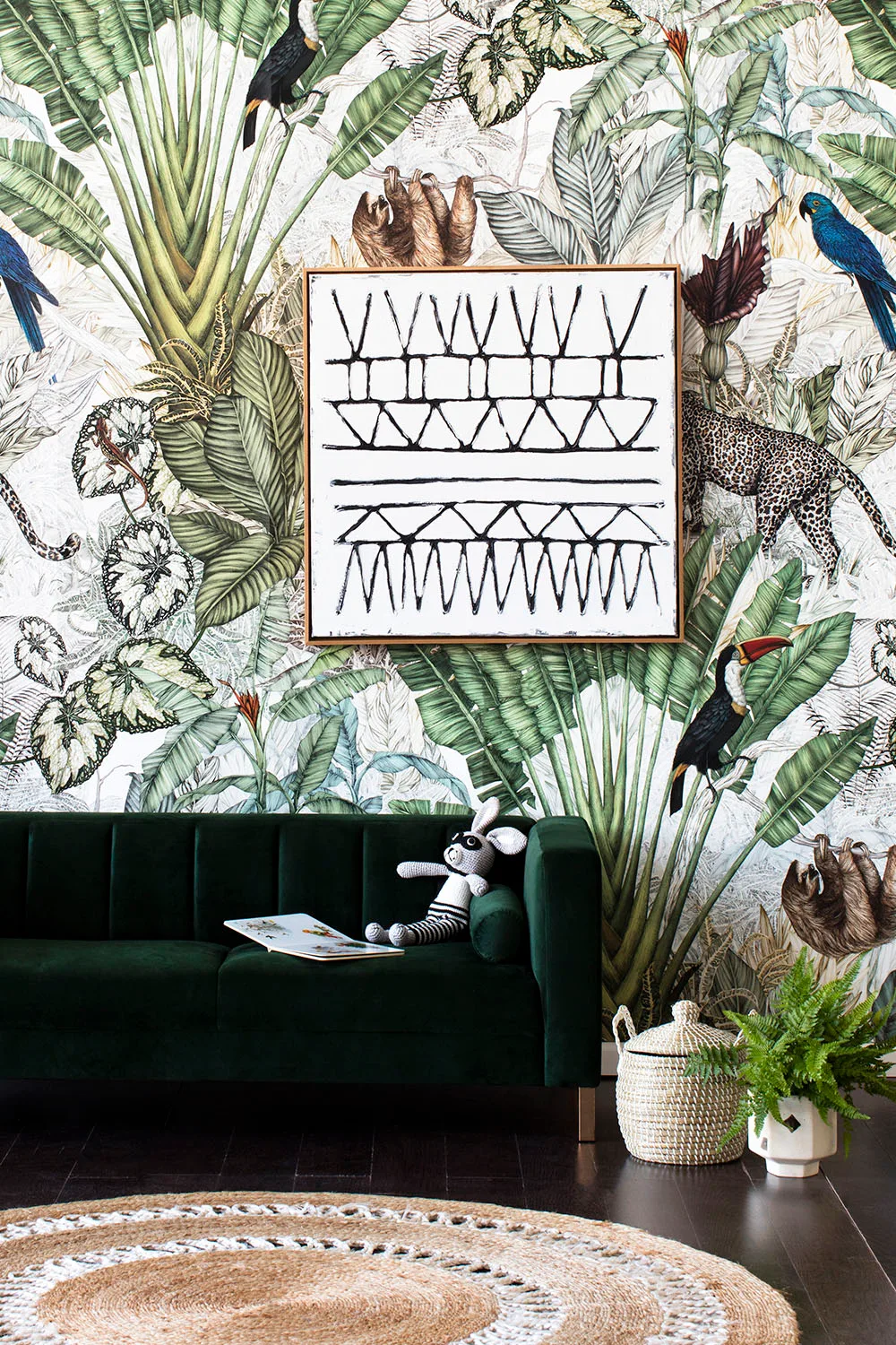 botanical print wallpaper with green velvet sofa
